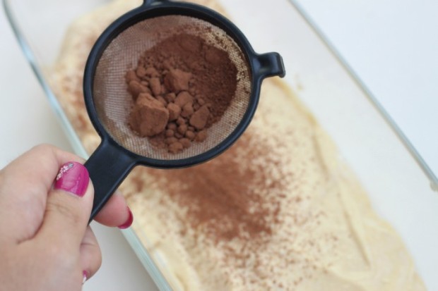 Dusting cocoa powder to finish the first layer of the Irish Cream Tiramisu!